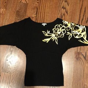 Cache black sweater with gold detail on one arm